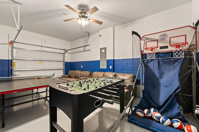 playroom featuring electric panel, ceiling fan, and a textured ceiling