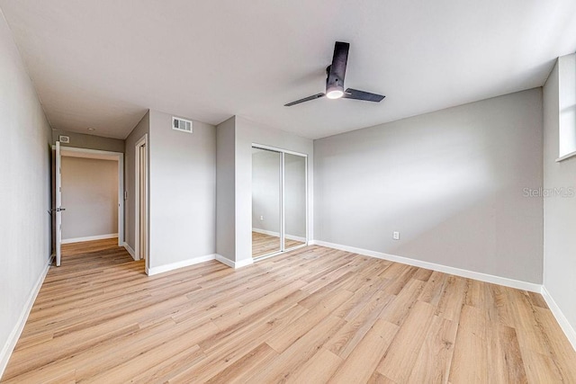 unfurnished bedroom with visible vents, baseboards, ceiling fan, light wood-style floors, and a closet