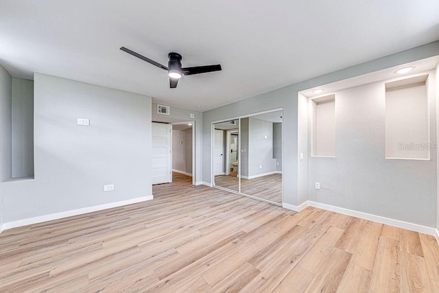 unfurnished room featuring light wood-style flooring, visible vents, ceiling fan, and baseboards