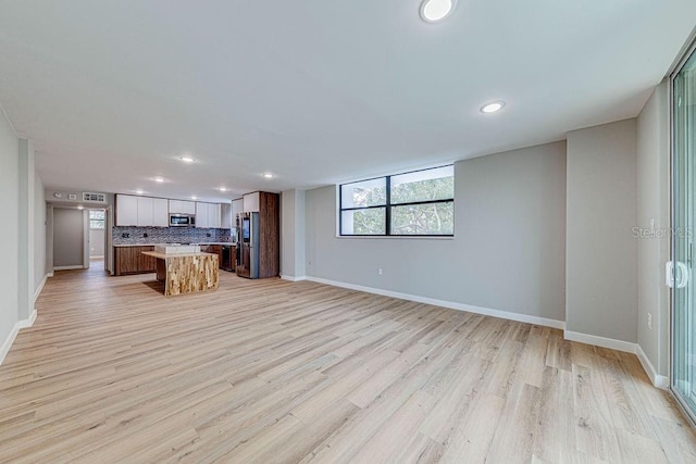 interior space featuring light wood-style floors, recessed lighting, and baseboards