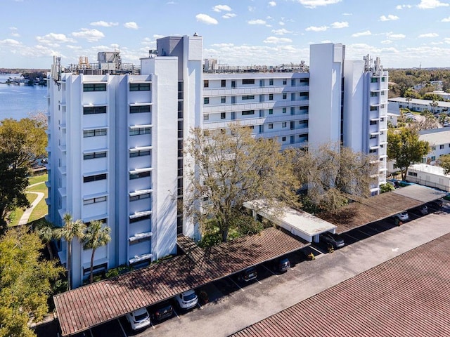 view of building exterior featuring a view of city and a water view