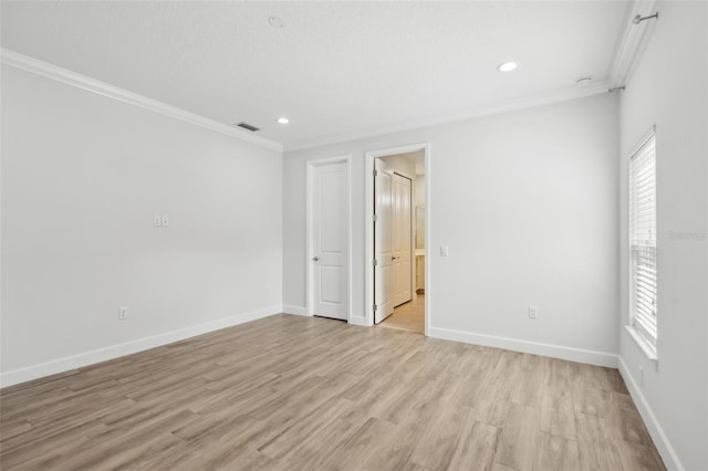 unfurnished room featuring light wood-type flooring and crown molding