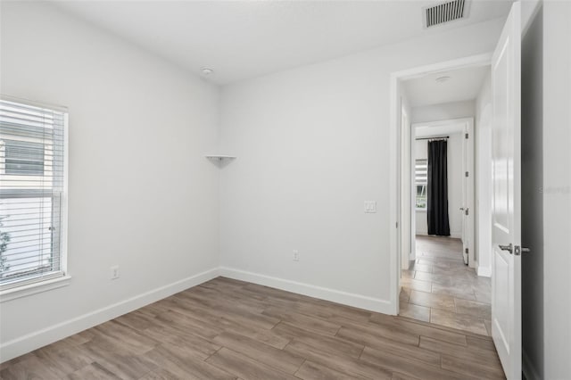 unfurnished room with light hardwood / wood-style floors