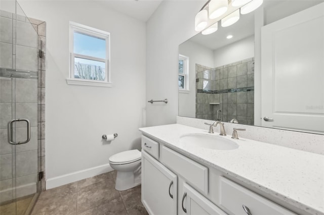 bathroom featuring tile patterned flooring, toilet, vanity, and walk in shower