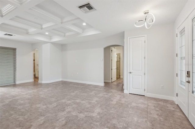 unfurnished room with coffered ceiling and beamed ceiling