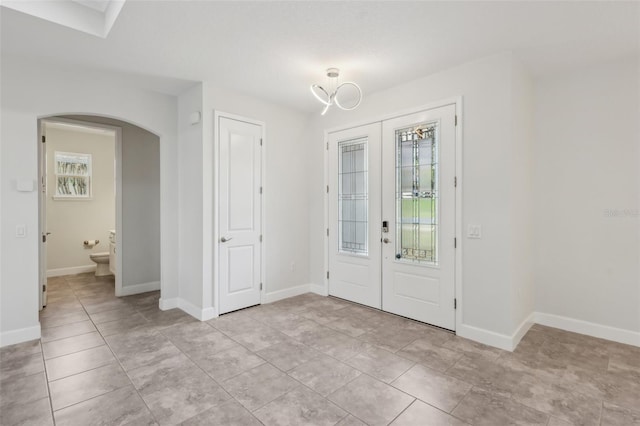 foyer entrance with french doors and light tile patterned floors