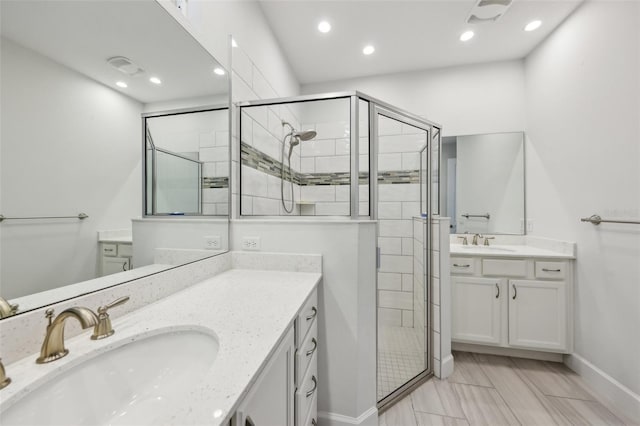 bathroom featuring an enclosed shower and vanity