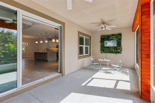 sunroom / solarium with sink and ceiling fan