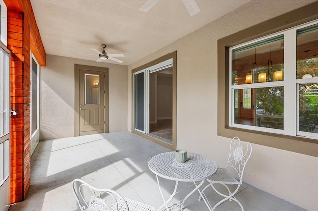 sunroom featuring ceiling fan