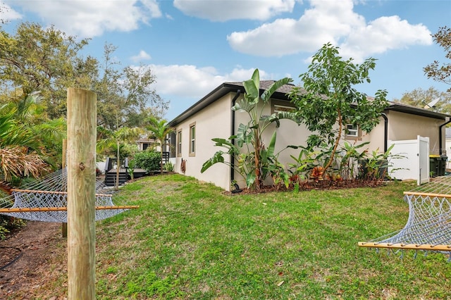 view of side of home with a lawn