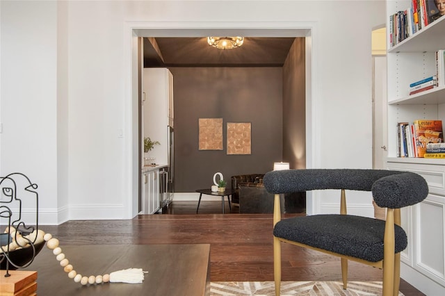 sitting room with wood finished floors and baseboards