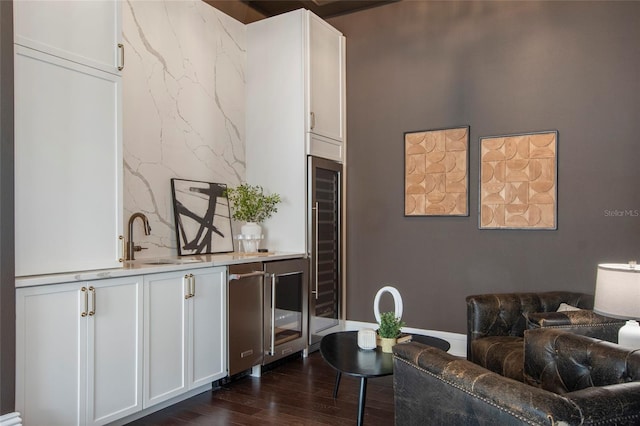 interior space featuring indoor wet bar, dark wood-style floors, and wine cooler