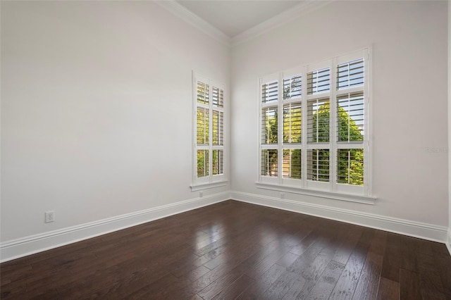 spare room with dark wood-type flooring, baseboards, and crown molding