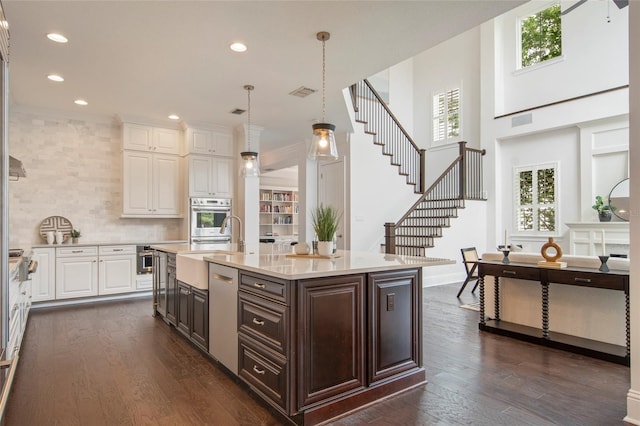 kitchen featuring dark brown cabinetry, recessed lighting, white cabinetry, dark wood-type flooring, and oven