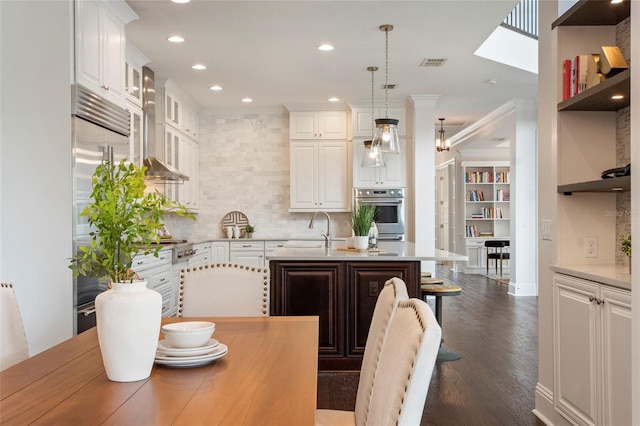 kitchen featuring dark wood finished floors, open shelves, visible vents, light countertops, and a sink