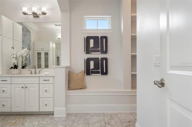 bathroom featuring visible vents, baseboards, marble finish floor, and vanity