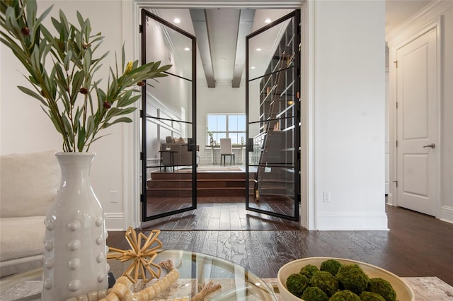 foyer with wood-type flooring, baseboards, and recessed lighting