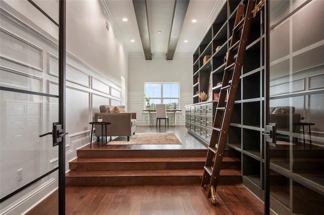 wine area with a decorative wall, ornamental molding, visible vents, recessed lighting, and hardwood / wood-style floors