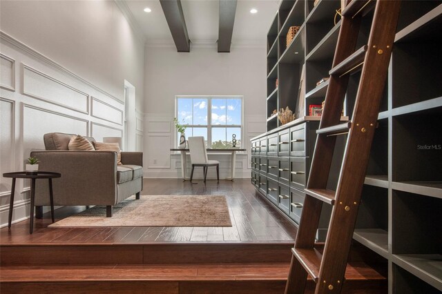 interior space featuring a decorative wall, ornamental molding, recessed lighting, wainscoting, and wood-type flooring