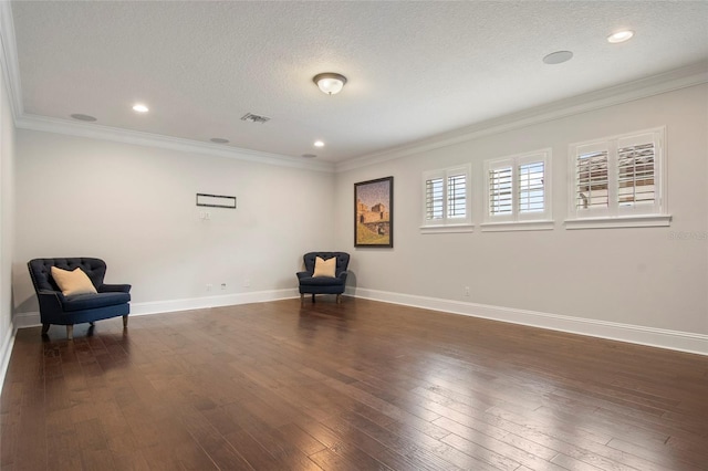 unfurnished room featuring dark wood-style flooring, visible vents, baseboards, and a textured ceiling