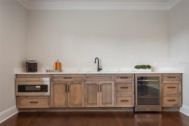 bar featuring a sink, baseboards, beverage cooler, and wall oven