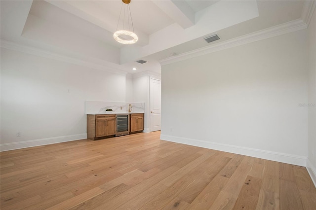 unfurnished room featuring wine cooler, baseboards, visible vents, and light wood-style floors