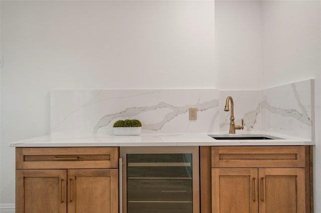 bar with indoor wet bar, a sink, and beverage cooler
