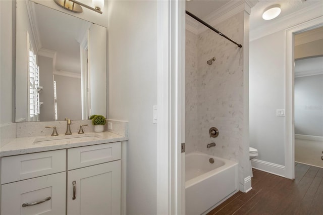 full bathroom featuring toilet, crown molding, vanity, wood finished floors, and bathing tub / shower combination