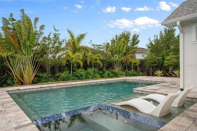 outdoor pool with a patio area