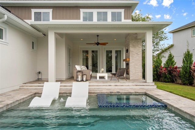 rear view of property with a patio, a pool with connected hot tub, french doors, and ceiling fan