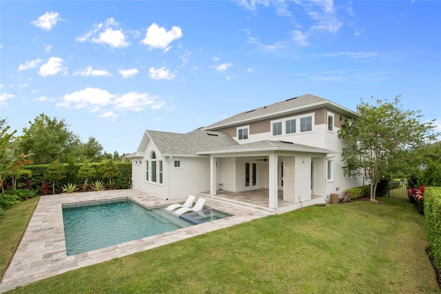 back of house featuring a shingled roof, a patio area, a ceiling fan, a lawn, and a fenced backyard