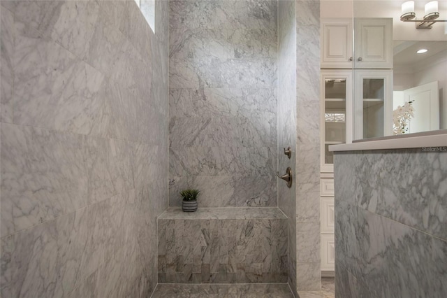 full bathroom with tile walls and walk in shower