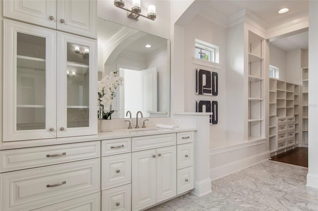 full bath featuring ornamental molding, a closet, vanity, and marble finish floor