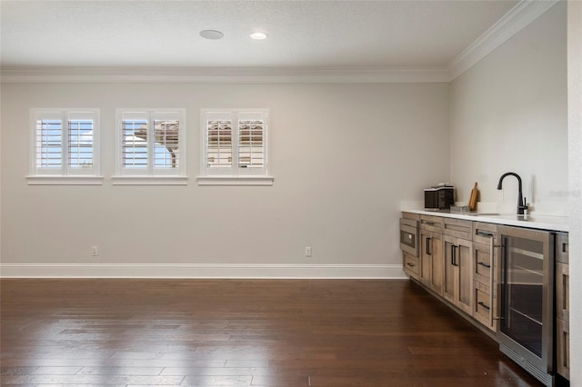 bar with a sink, ornamental molding, beverage cooler, and dark wood-type flooring