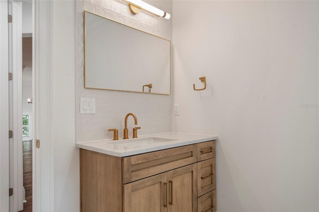 bathroom with tasteful backsplash and vanity