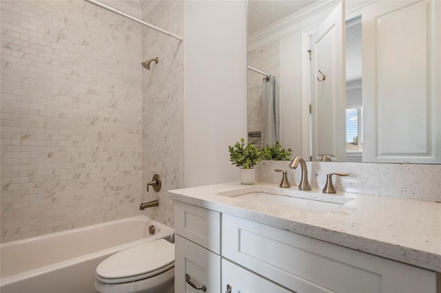 bathroom with vanity, ornamental molding, toilet, and shower / washtub combination
