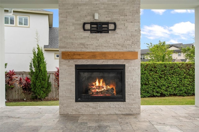 details with fence and a glass covered fireplace