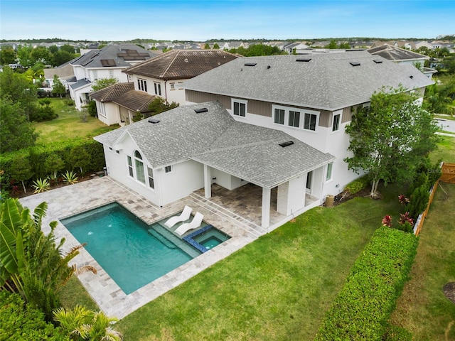 exterior space featuring a residential view, roof with shingles, stucco siding, a patio area, and a lawn