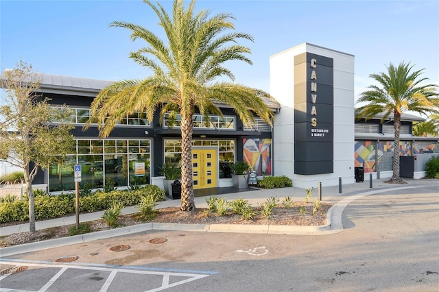 view of building exterior with uncovered parking