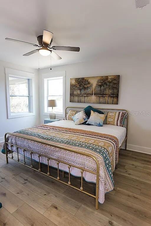 bedroom featuring ceiling fan and wood-type flooring