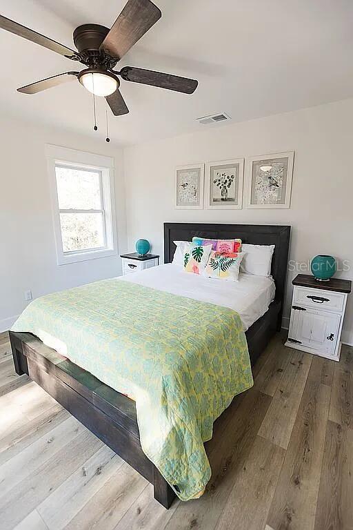 bedroom with hardwood / wood-style flooring and ceiling fan