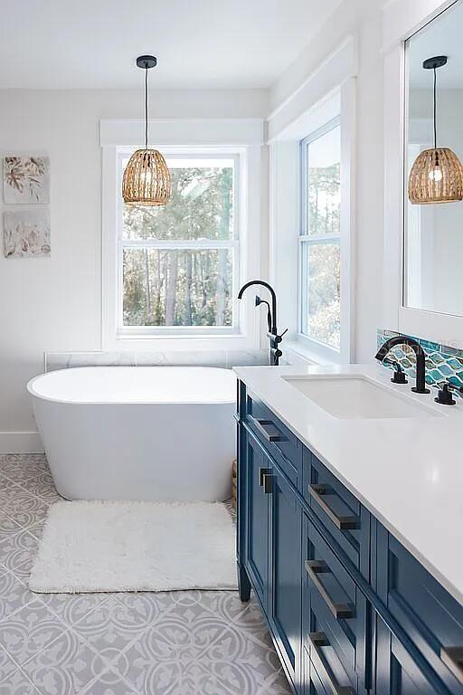 bathroom with vanity and a washtub