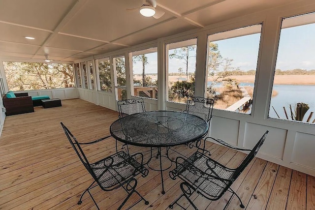 sunroom featuring a water view and coffered ceiling