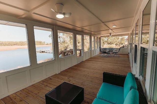 sunroom with ceiling fan, a water view, plenty of natural light, and coffered ceiling