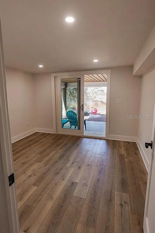 empty room with hardwood / wood-style flooring