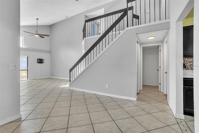 1008 Birkdale Trl, Winter Springs, FL 32708 - interior space featuring ceiling fan, a high ceiling, light tile patterned flooring, and baseboards