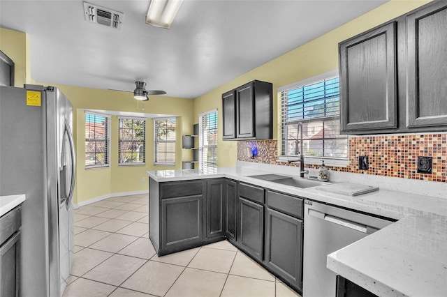 1008 Birkdale Trl, Winter Springs, FL 32708 - kitchen with light tile patterned floors, visible vents, appliances with stainless steel finishes, a peninsula, and a sink
