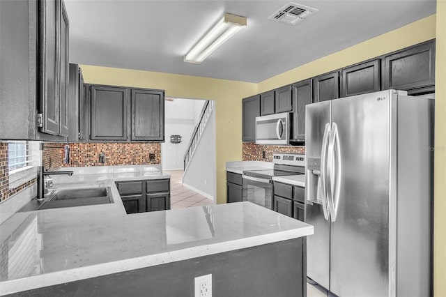 1008 Birkdale Trl, Winter Springs, FL 32708 - kitchen featuring tasteful backsplash, visible vents, light stone countertops, stainless steel appliances, and a sink