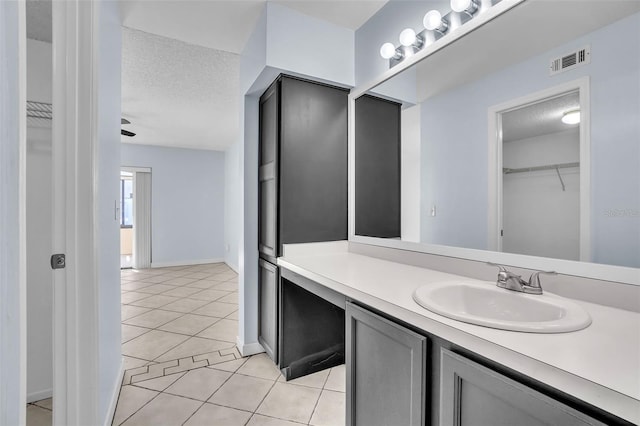 1008 Birkdale Trl, Winter Springs, FL 32708 - bathroom with visible vents, tile patterned flooring, a spacious closet, a textured ceiling, and vanity