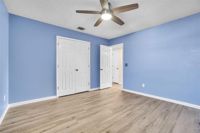 1008 Birkdale Trl, Winter Springs, FL 32708 - unfurnished bedroom featuring baseboards, visible vents, a textured ceiling, light wood-type flooring, and a closet